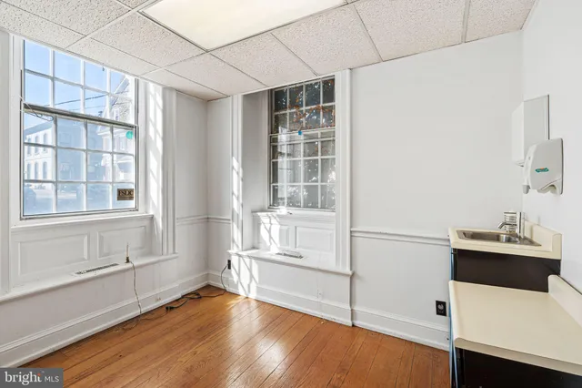 a room with a window and wooden floor