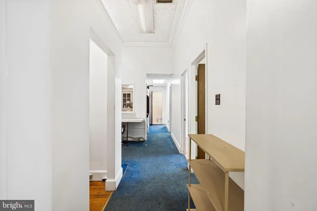 a view of a hallway with living room