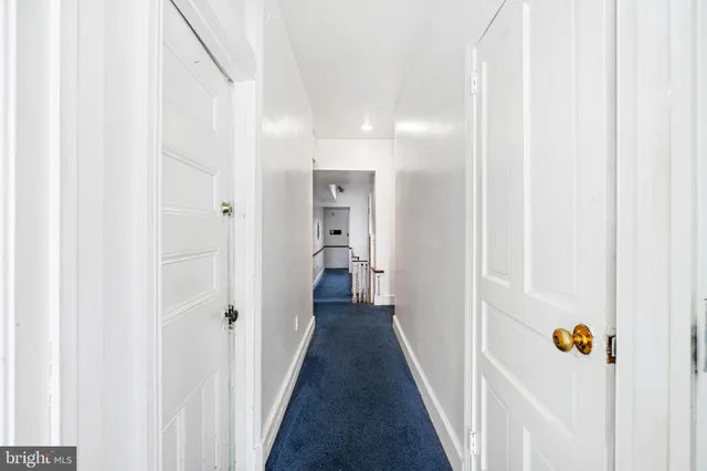 a view of a hallway with a wooden floor
