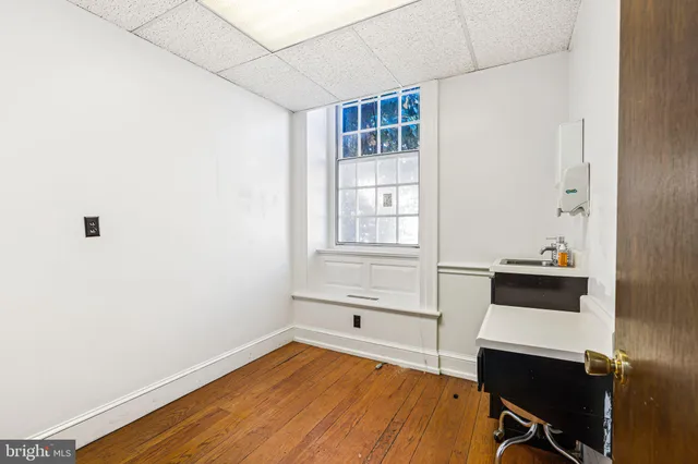 a room with a window and wooden floor