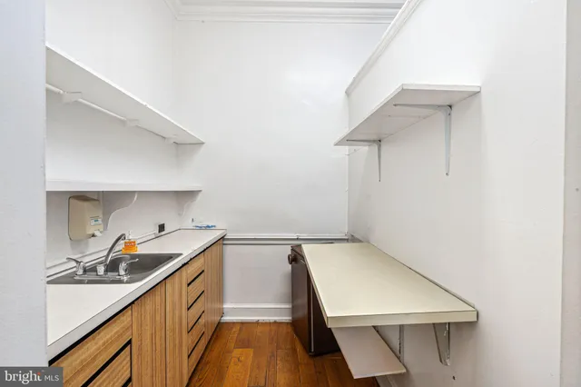 a view of a kitchen with a sink and cabinets