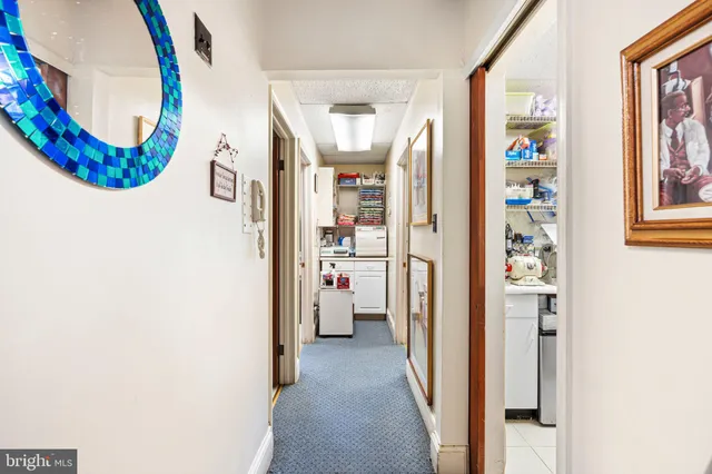 a view of a hallway with wooden floor and windows