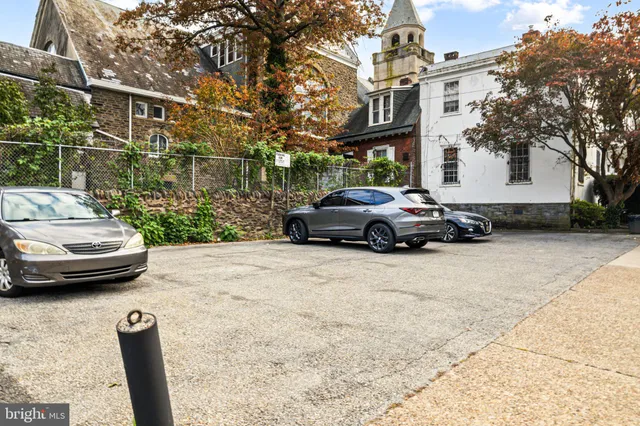 a car parked in front of a brick house