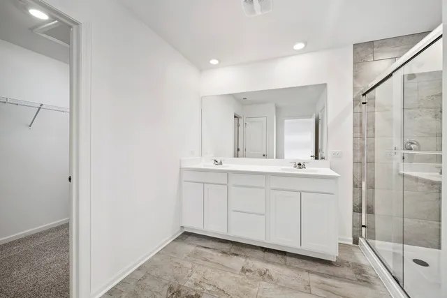 a bathroom with double vanity sink and mirror