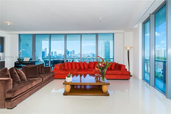 a living room with furniture a rug and a large window