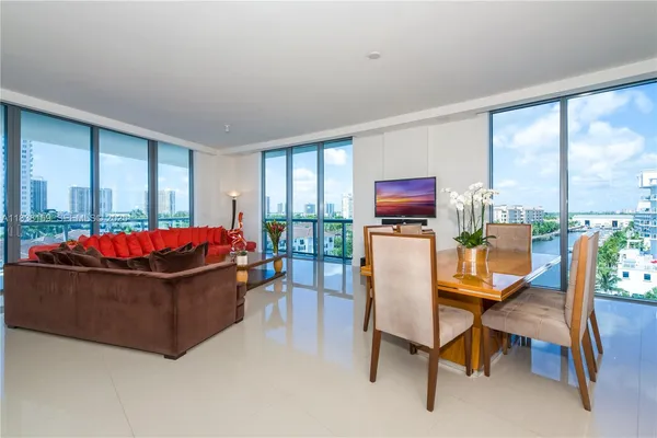 a living room with furniture and a floor to ceiling window