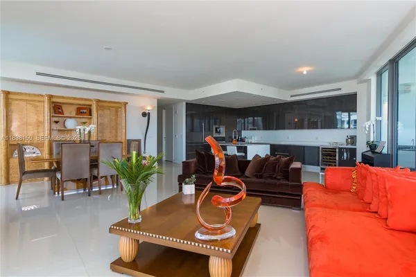 a living room with furniture a fireplace and a potted plant
