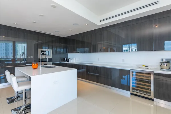 a kitchen with stainless steel appliances a stove a sink a refrigerator and cabinets