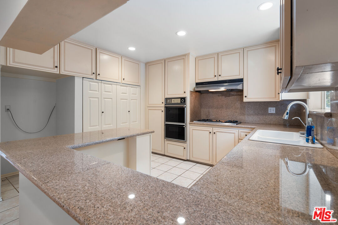9631 Crystal View Drive Tujunga, CA 91042 - Photo 23 of 37 a kitchen with white cabinets and sink