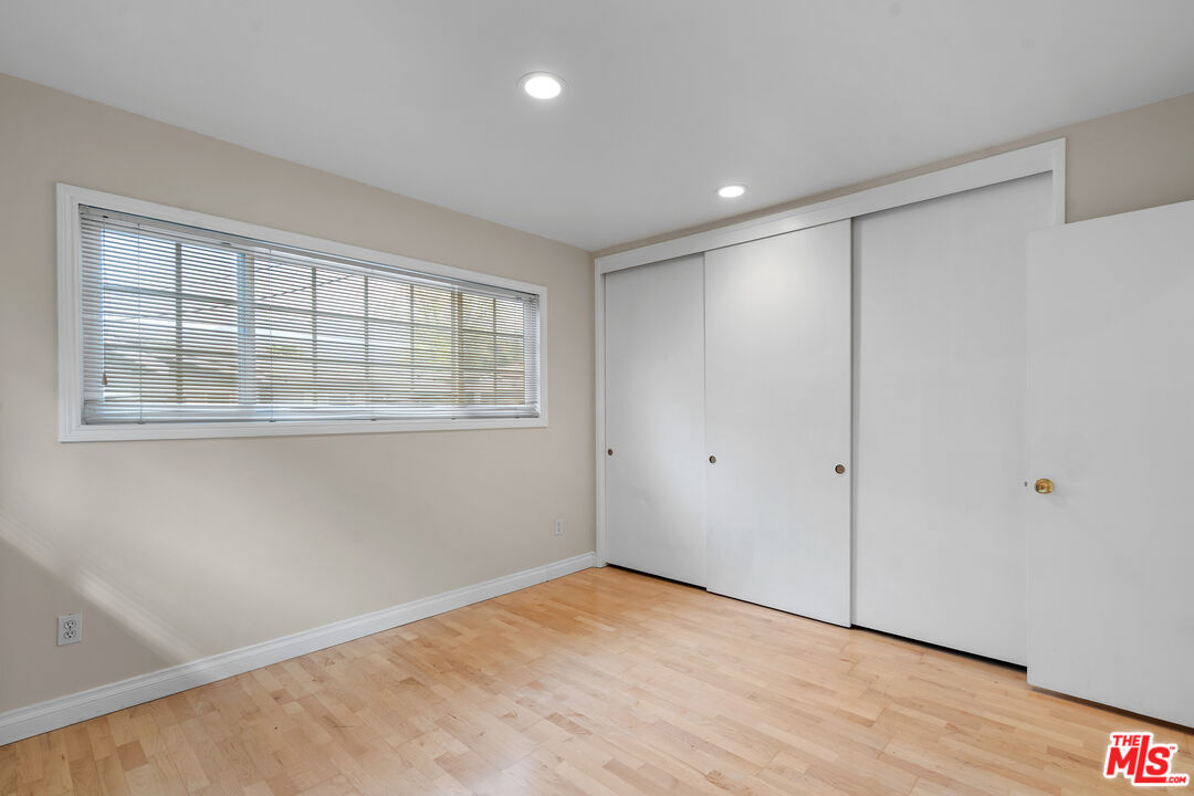 9631 Crystal View Drive Tujunga, CA 91042 - Photo 29 of 37 a view of an empty room with wooden floor and a window