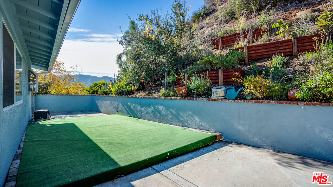 9631 Crystal View Drive Tujunga, CA 91042 - Photo 3 of 37 a view of a backyard with potted plants and a fountain