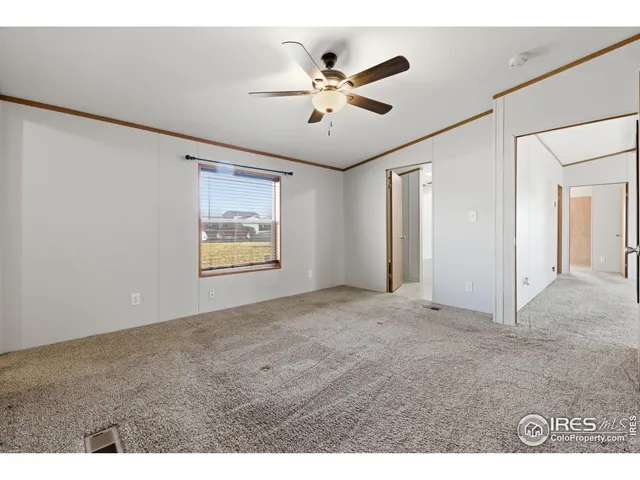 a view of an empty room with a ceiling fan