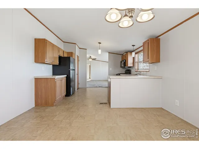 a kitchen with a refrigerator and a stove top oven