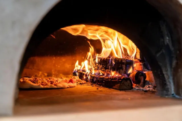 a white bath tub sitting in a bathroom next to a window