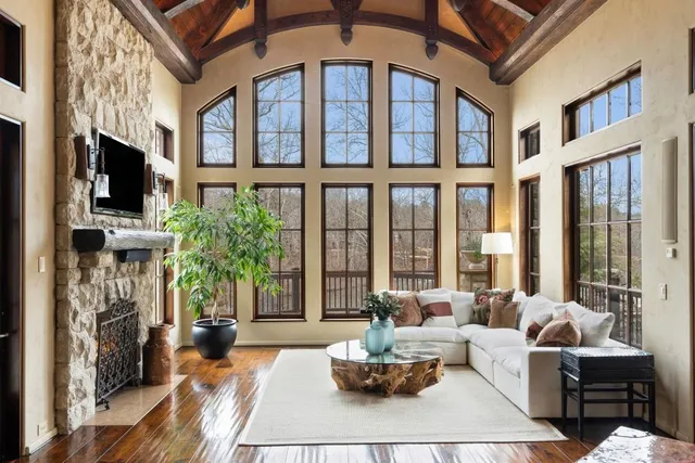 a living room with furniture a window and a lamp