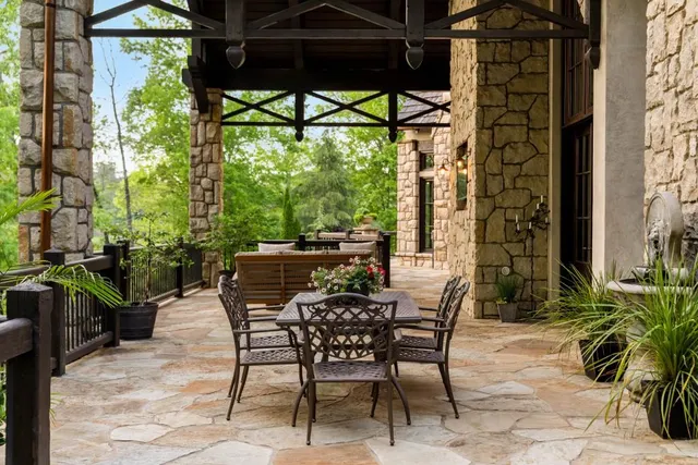 a spacious bathroom with a granite countertop tub a sink and a large mirror