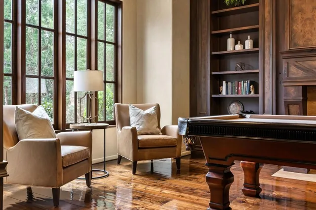 a bedroom with a bed a lamp and a flat screen tv