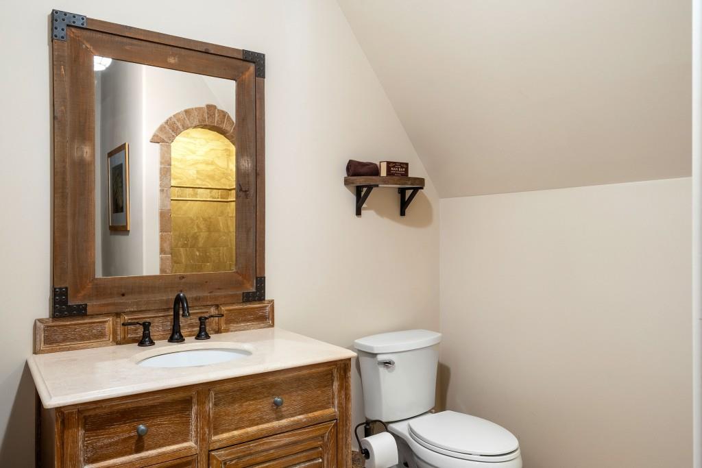 550 Blue Heron Way Milton, GA 30004 - Photo 73 of 108 a bathroom with a granite countertop toilet a sink and mirror