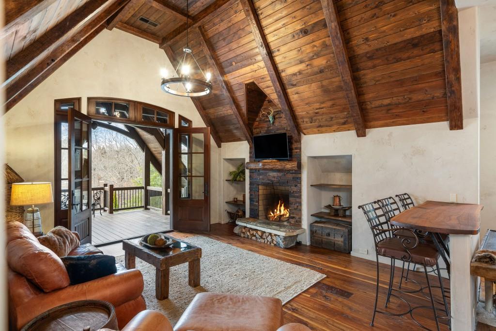 550 Blue Heron Way Milton, GA 30004 - Photo 86 of 108 a living room with furniture a fireplace and a table