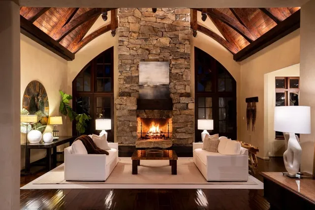 a view of a dining room with furniture a chandelier and wooden floor