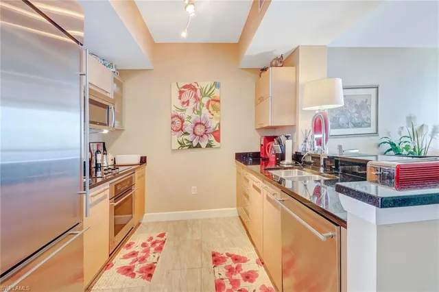 a kitchen with a sink stove and refrigerator