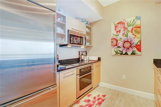 a kitchen with stainless steel appliances a stove a microwave and cabinets