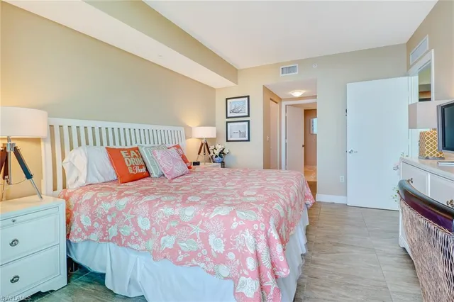 a bed room with a bed and a television