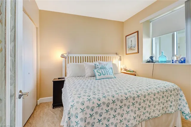 a bedroom with a bed and a night stand