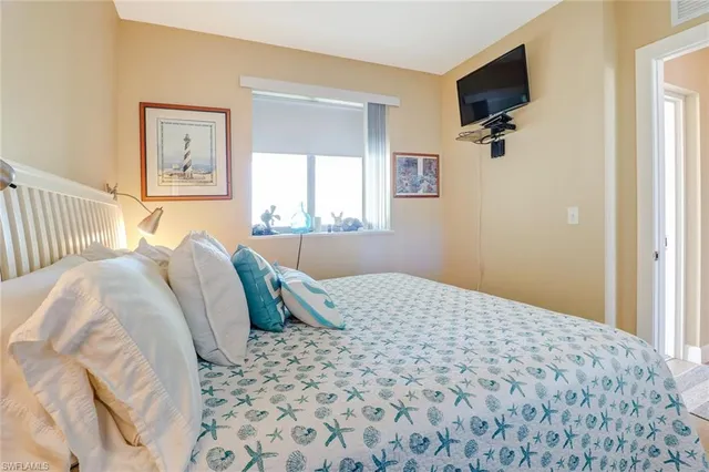 a bedroom with a bed and a flat screen tv