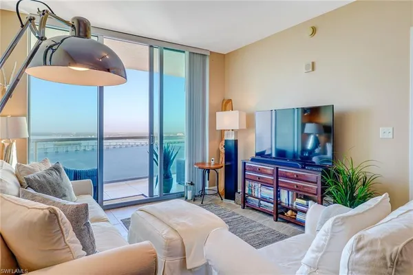 a living room with furniture and a lamp
