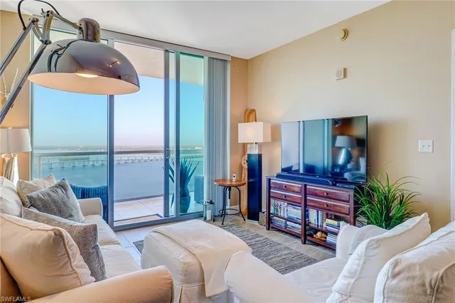 a living room with furniture and a lamp