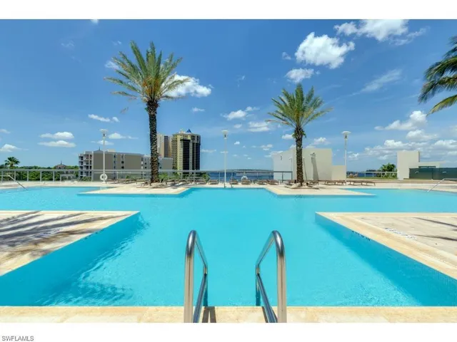 a swimming pool with outdoor seating and yard