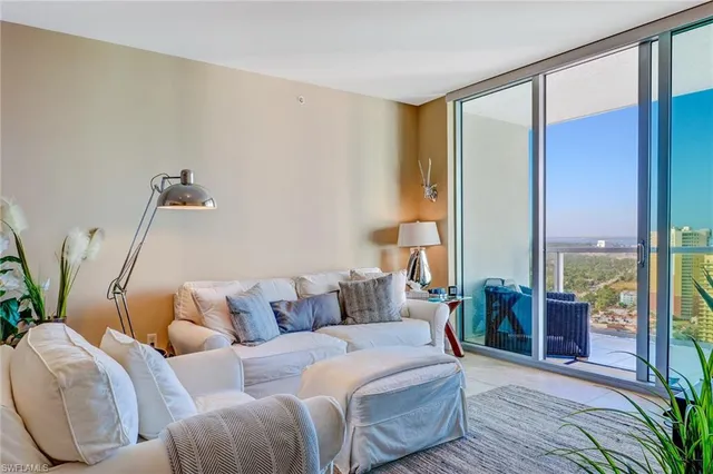 a living room with furniture and large window
