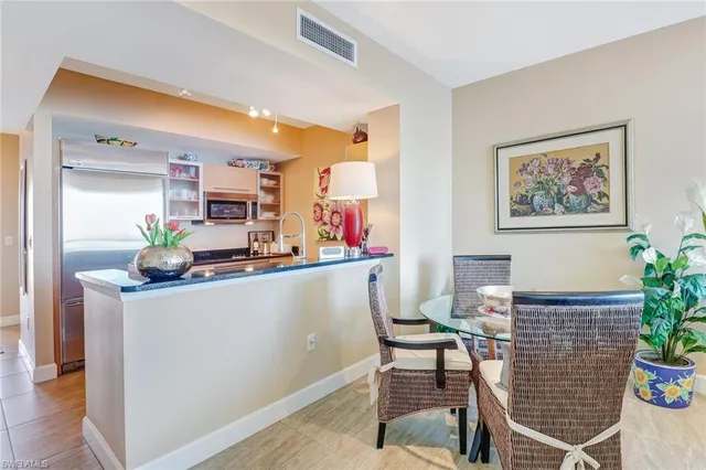 a living room with furniture and flowers