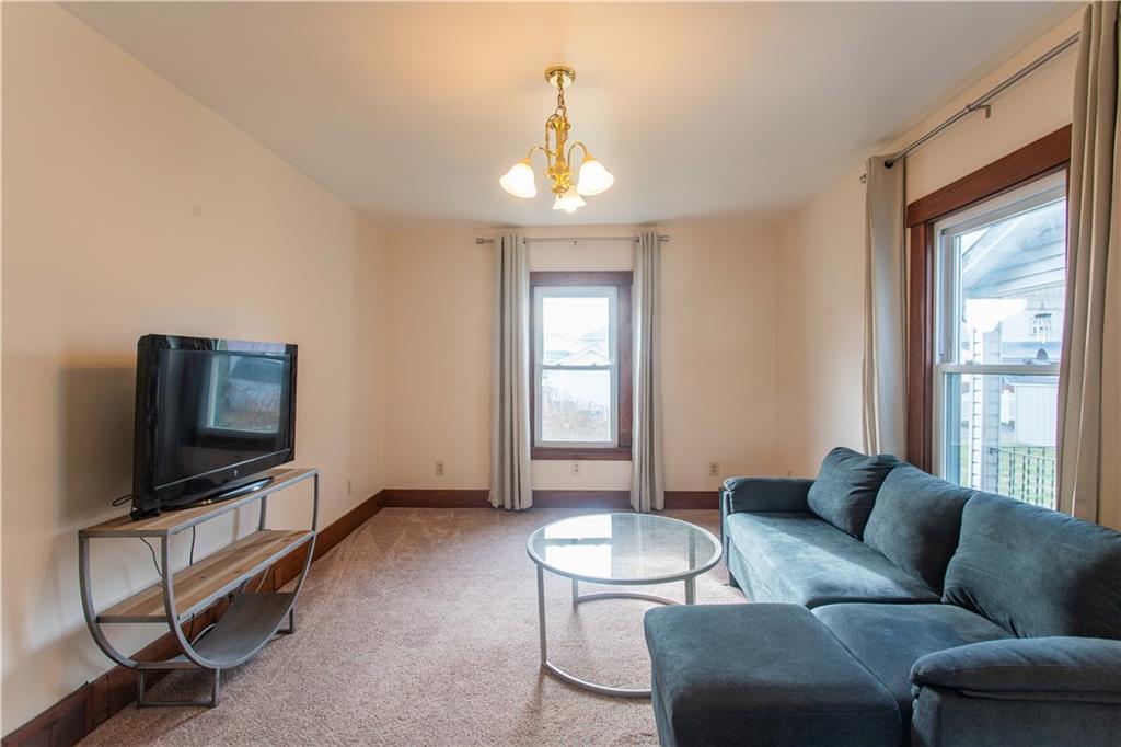1618 North 3rd Street New Brighton, PA 15066 - Photo 11 of 28 a living room with furniture a flat screen tv and a window
