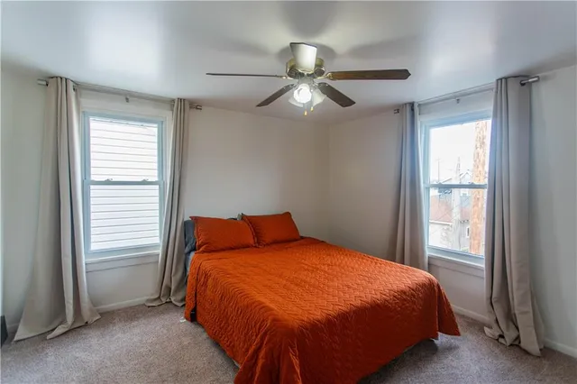 a bedroom with a bed and window