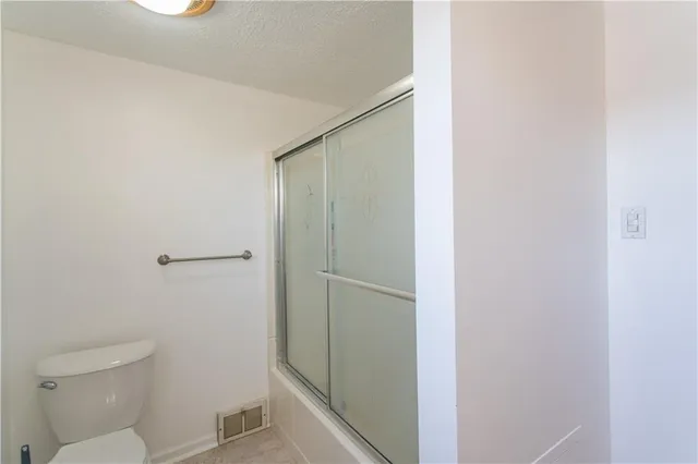 a bathroom with a shower and a toilet