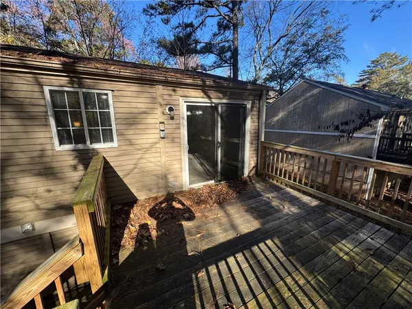 a view of a house with backyard and deck