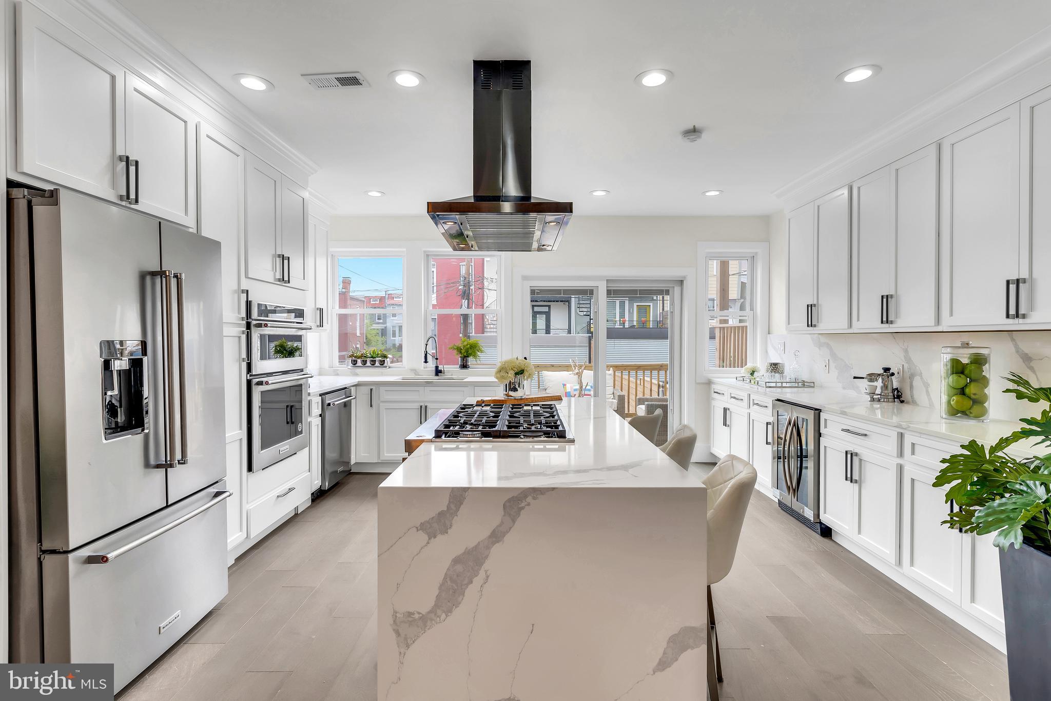 112 Todd Place Northeast Washington, DC 20002 - Photo 15 of 73 a large kitchen with stainless steel appliances lots of counter space and a refrigerator