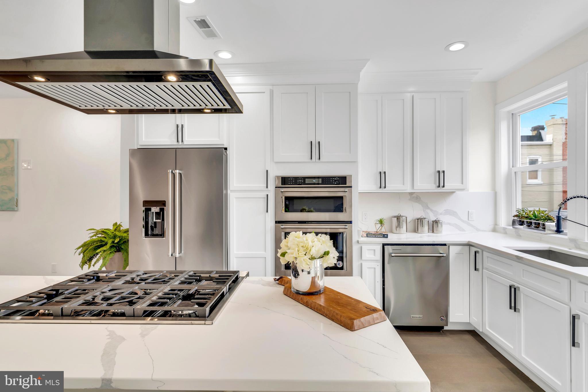 112 Todd Place Northeast Washington, DC 20002 - Photo 19 of 73 a kitchen with stainless steel appliances a stove a sink a refrigerator and cabinets
