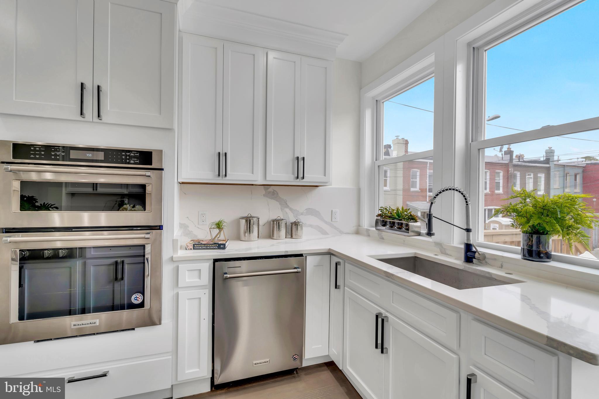 112 Todd Place Northeast Washington, DC 20002 - Photo 23 of 73 a kitchen with white cabinets and white appliances