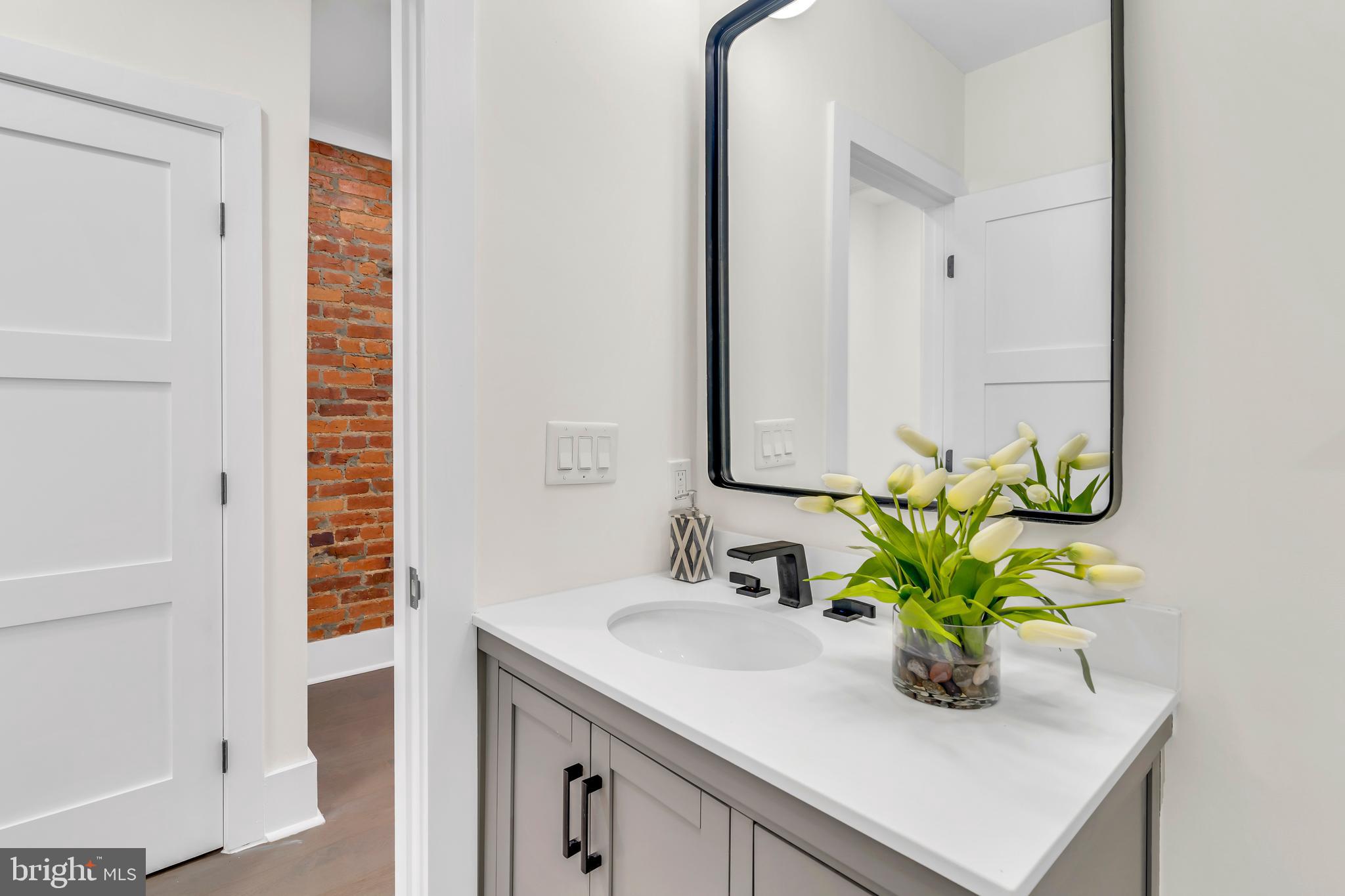 112 Todd Place Northeast Washington, DC 20002 - Photo 42 of 73 a bathroom with a sink a vanity and a mirror