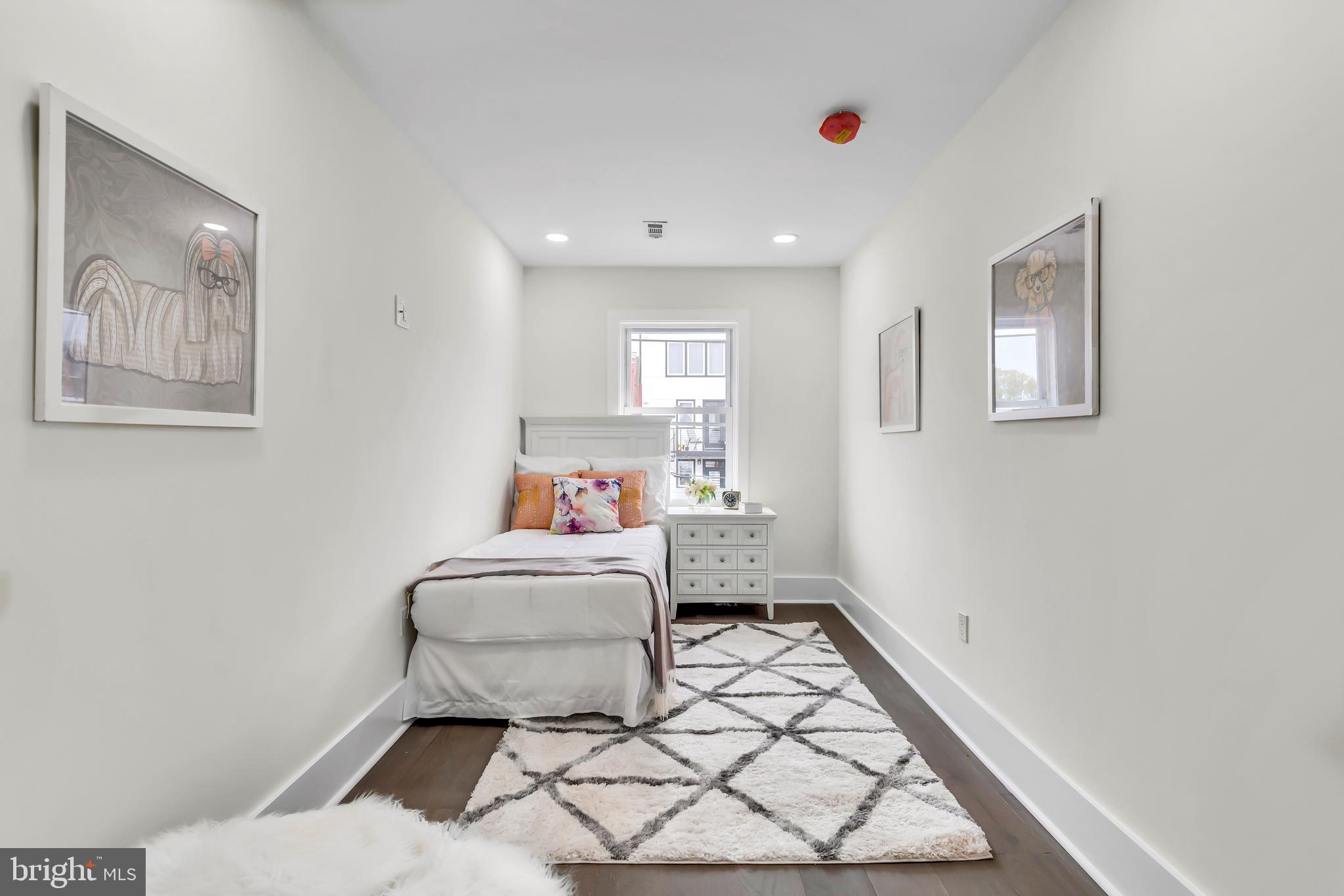 112 Todd Place Northeast Washington, DC 20002 - Photo 51 of 73 a bedroom with a bed and a lamp with wooden floor