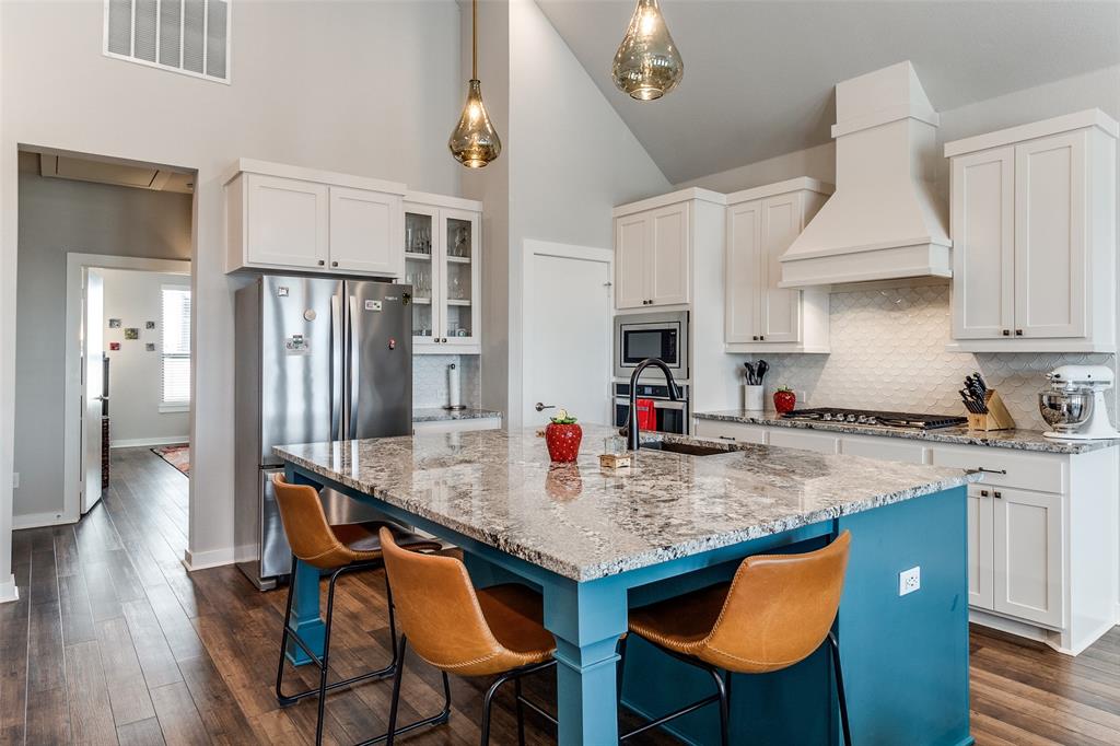 2220 Rook Drive Dallas, TX 75211 - Photo 5 of 12 a kitchen with stainless steel appliances granite countertop a kitchen island a table and chairs in it