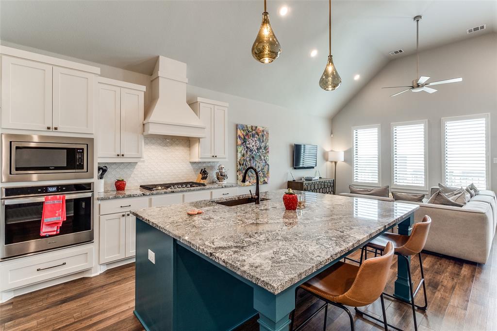 2220 Rook Drive Dallas, TX 75211 - Photo 6 of 12 a kitchen with a stove center island a table and chairs in it