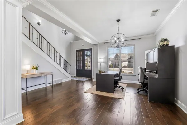 a living room with furniture a fireplace and a large window