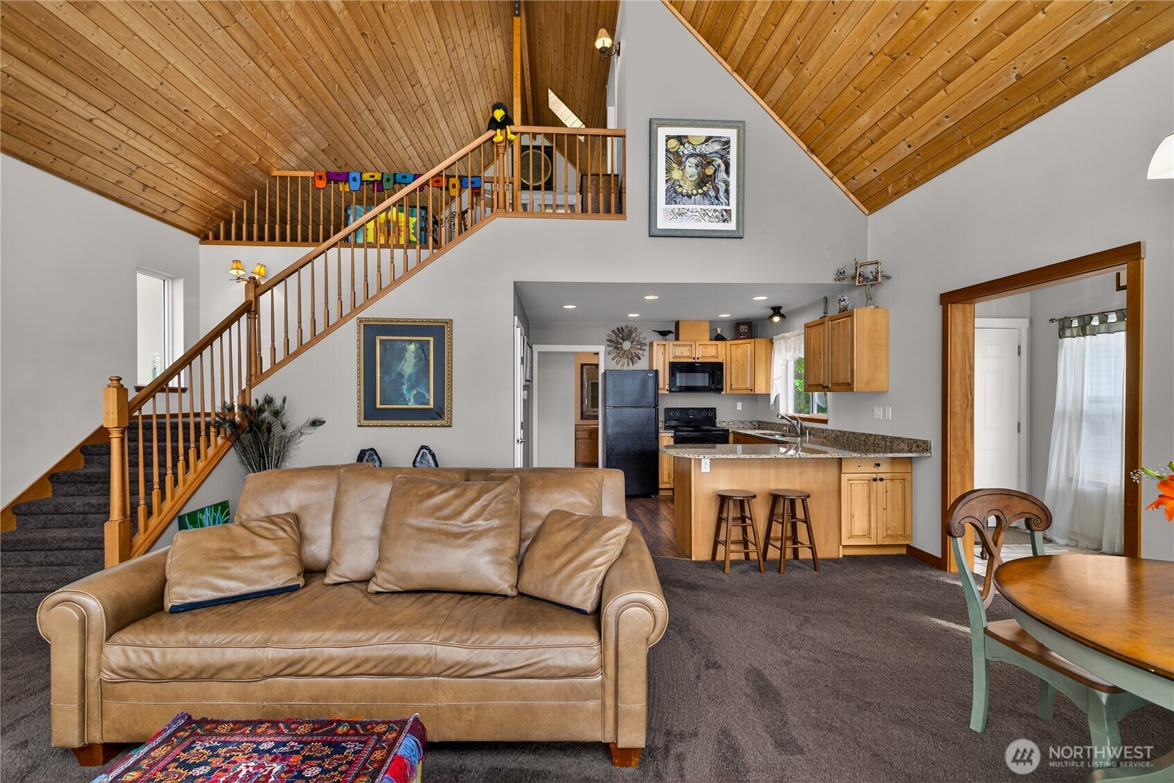 17946 Cobahud Road La Conner, WA 98257 - Photo 23 of 40 a living room with furniture a fireplace and kitchen view