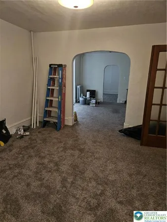a view of a livingroom with furniture and staircase