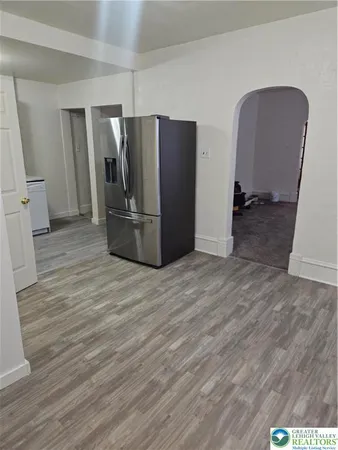 a view of a refrigerator in kitchen and wooden floor