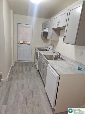 a kitchen with a sink and a refrigerator